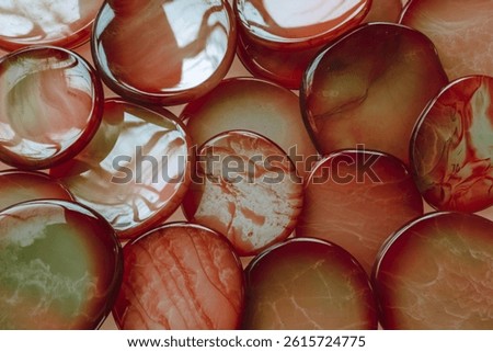 a collection of translucent, circular objects with varying shades of red