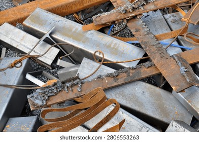 A collection of various knives and kitchen tools scattered on a wooden table.
