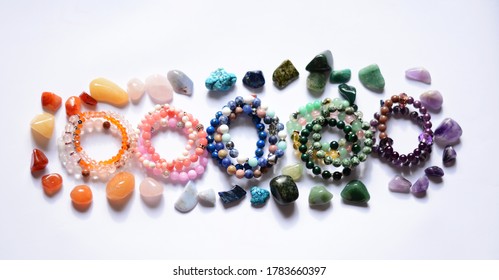 Collection of various raw mineral gemstones with handmade bracelets