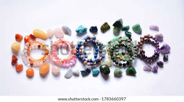 Collection of various raw mineral gemstones\
with handmade\
bracelets
