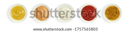 Collection of various sauces in white ceramic bowl top view. Mustard, burger sauce, tartar, ketchup isolated on white background.                               Stockfoto © 