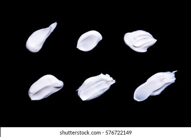 Collection Of Various Strokes Of A White Beauty Cream On Black Background