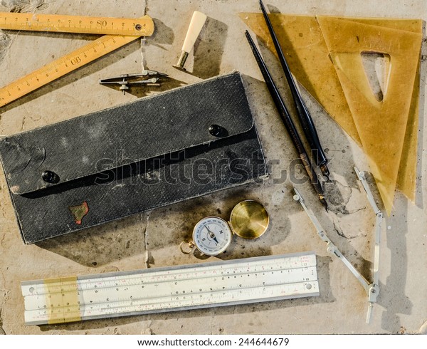 A collection of\
vintage drafting tools