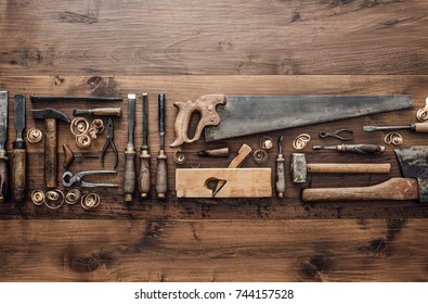 Collection of vintage woodworking tools on a rough workbench and blank copy space: carpentry, craftsmanship and handwork concept, flat lay - Powered by Shutterstock