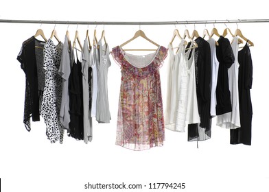 Collection Of Women's Clothes Hanging On A Rack.