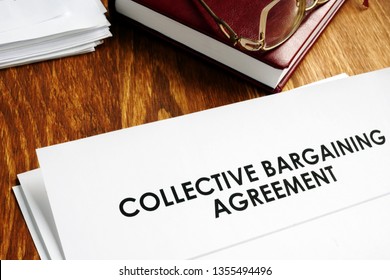 Collective bargaining agreement and note pad with glasses. - Shutterstock ID 1355494496