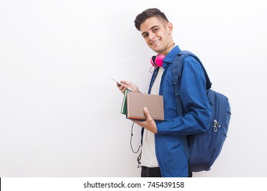 College Adolescent Student With Mobile Phone And Books