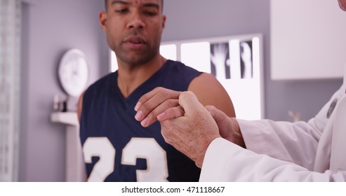 College Basketball Player With Sports Injury Being Examined By Doctor.