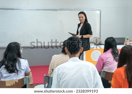 College female teacher teaching students in the classroom