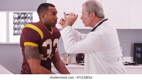 College Football Player Having Senior Doctor Review His Concussion Injury.