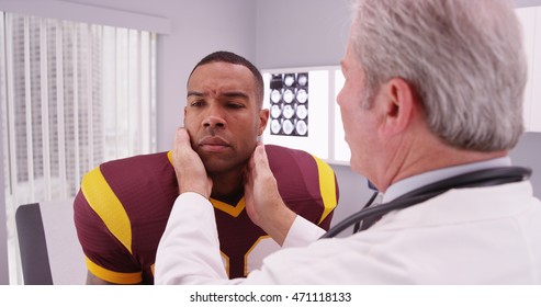 College Football Player Having Senior Doctor Review His Concussion Injury.