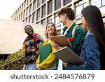 College friends walk to class together. Multiracial university students in campus talk and have fun outdoors. Higher education concept.