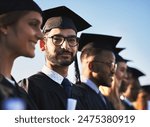 College, graduation and portrait of student man outdoor with friends for ceremony or event together. Diversity, education and success with happy graduate on academy campus for development or future