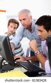 College Lecturer Showing Students Something On The Computer