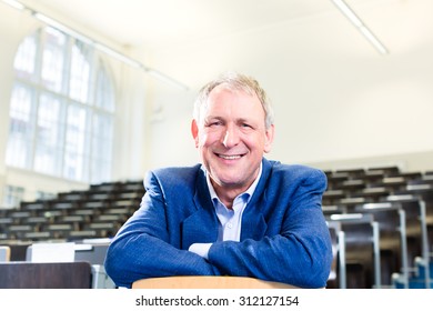 College Professor Giving Lecture And Standing At Desk