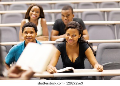 College Professor Lecturing Group Of African Students In Classroom