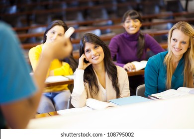 College Professor Lecturing Group Of Students In Classroom