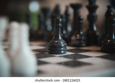 College Station, TX USA - April 16 2020: A Game Of Chess Being Played With A Pawn Piece In Focus Making The First Move In An Intense Strategic Match