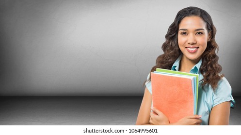 College student with books against grey wall - Shutterstock ID 1064995601