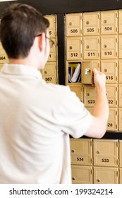 College Student Checking Mail At Mailboxed.