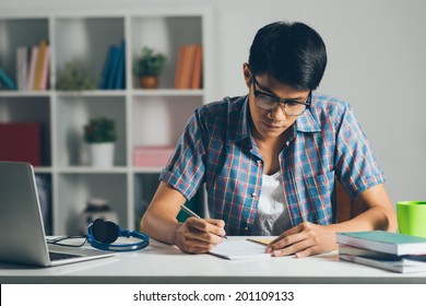 College Student Doing Homework At Home