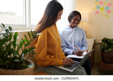 College Student Explaining Diffucult Topic To Friend When They Are Sitting In Dormitory Room