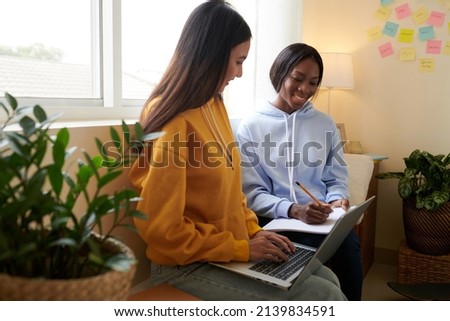 College student explaining diffucult topic to friend when they are sitting in dormitory room