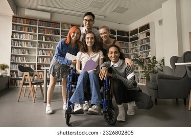 College student friends and classmate girl with disability posing in campus library, standing together, looking at camera, smiling, laughing, promoting inclusive educational environment - Powered by Shutterstock