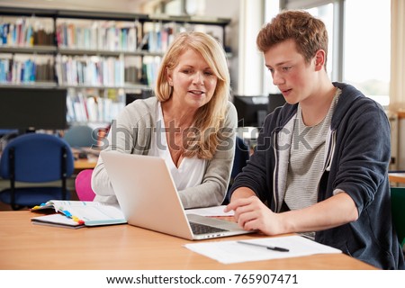 College Student Has Individual Tuition From Teacher In Library