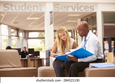 College Student Having Meeting With Tutor To Discuss Work