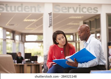 College Student Having Meeting With Tutor To Discuss Work