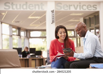 College Student Having Meeting With Tutor To Discuss Work