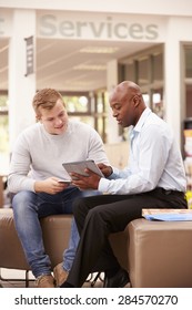 College Student Having Meeting With Tutor To Discuss Work