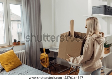 A college student is moving in a dormitory