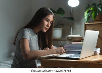 College Student Studying At Home Via Internet Computer At Night