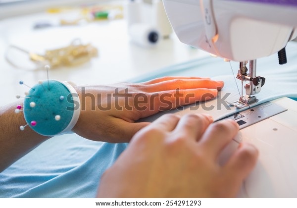 College\
student using sewing machine at the\
college