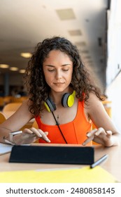 College student using a tablet in the faculty library