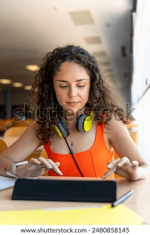 College student using a tablet in the faculty library