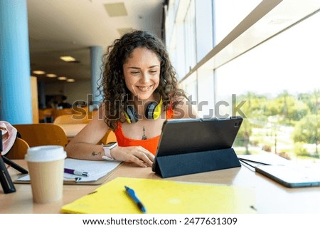 College student using a tablet to study in the faculty library