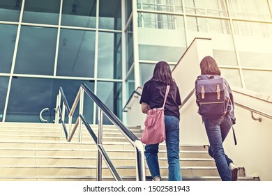 College Student Walking Up The Staircase