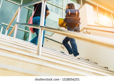 College Student Walking Up The Staircase