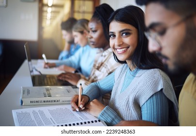 College student writing notes for business management in classroom, course and campus. Portrait, young indian girl and university student happy for learning, education and studying at finance academy - Powered by Shutterstock