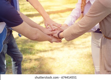 College students. Concept - Teamwork stacking hand.