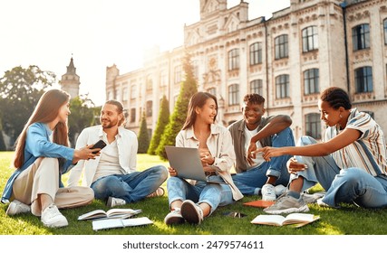 College students engage in academic discussions and study together outdoors near campus, benefiting from a multicultural environment and promoting teamwork in their learning processes - Powered by Shutterstock