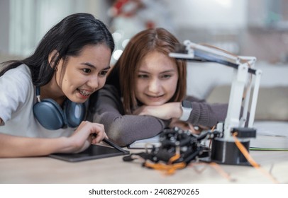 College students engage in active learning and experimental exploration with STEM educational robots at home. Applying textbooks, integrating concepts from engineering, programming, problem-solving.