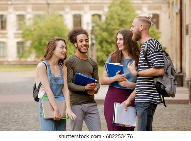 College Students Going To Classes, Talking And Laughing. Friends Meeting In Campus Before Classes.