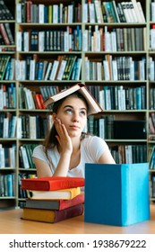 College Students Overwhelmed, Overworked, Burned Out, Perfectionists. Teen Tired Girl, Young Woman Sitting At Table With Books In College Library