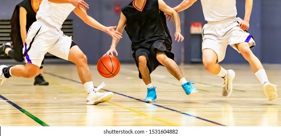 College Students Playing Basketball Games At The Gymnasium