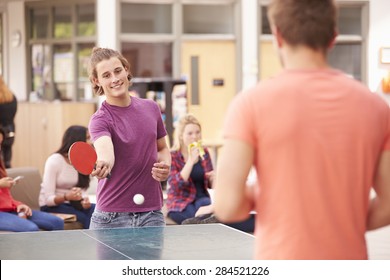 College Students Relaxing And Playing Table Tennis