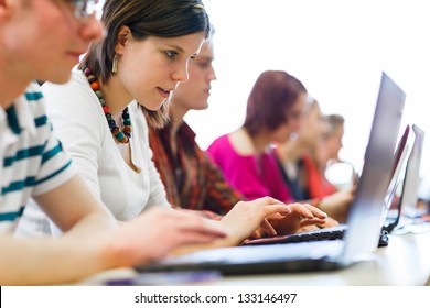 College students sitting in a classroom, using laptop computers during class (shallow DOF)